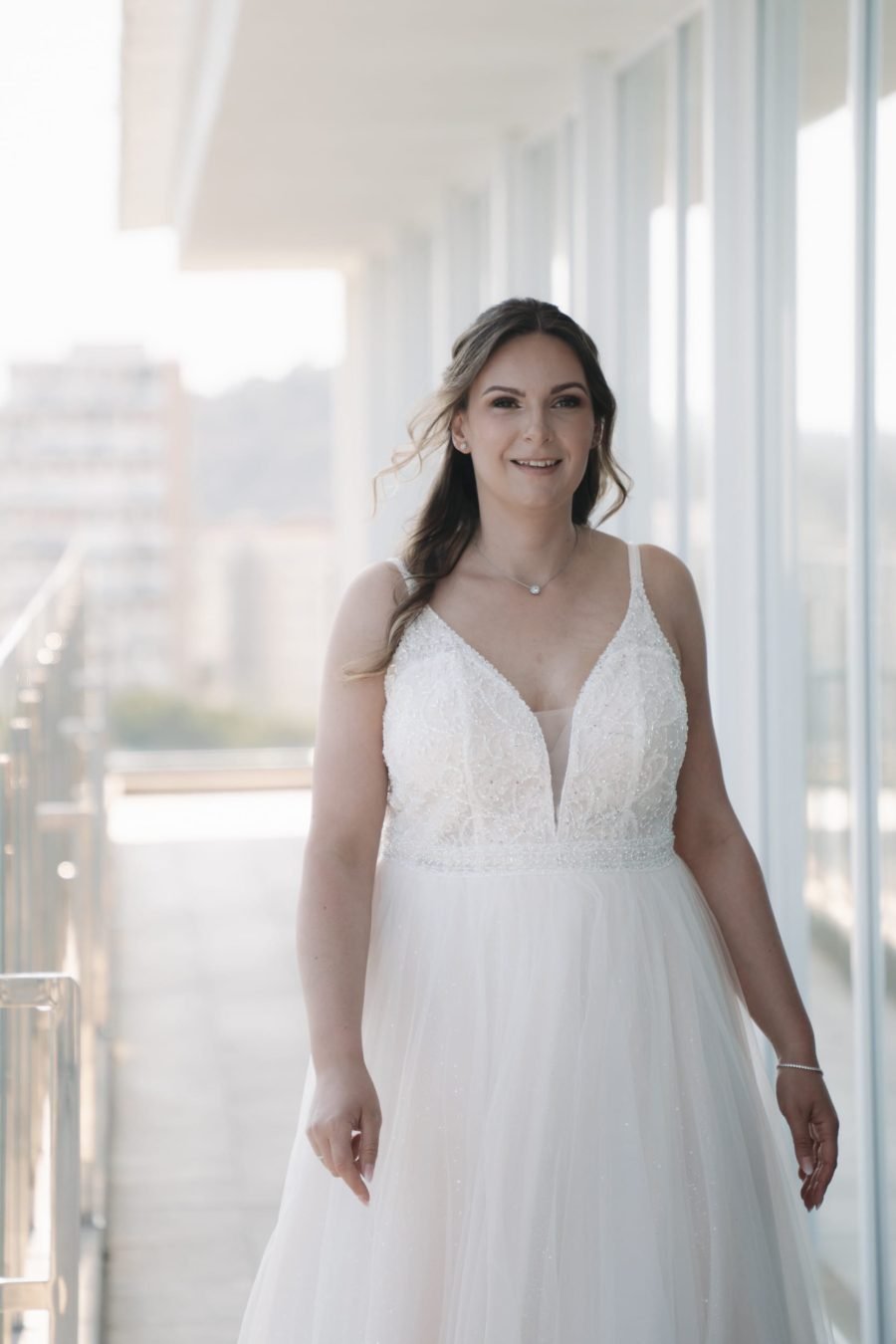 Braut im weißen Hochzeitskleid in heller Atmosphäre